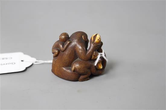 A Japanese stained ivory okimono carved as a group of apes, width 4.5cm, height 3.5cm